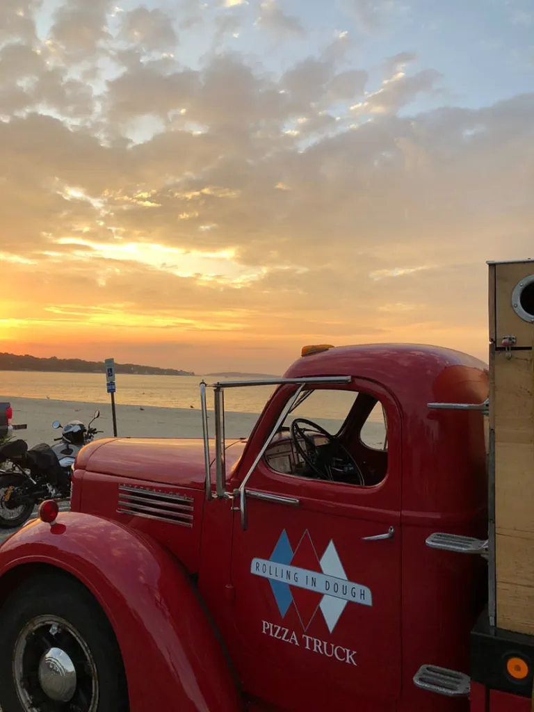 A food truck with a sunset in the background